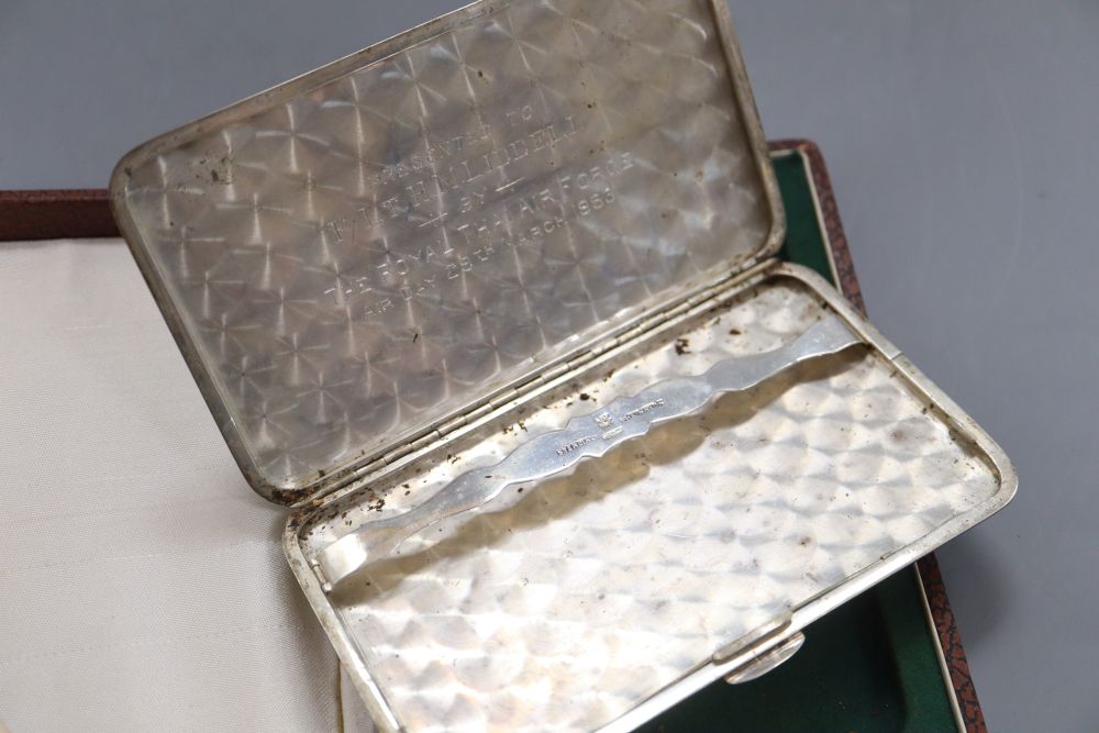 A cased mid 20th century Siamese sterling and niello cigarette case, 13.8cm, gross 5oz.